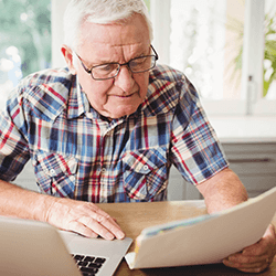 a senior man looking over paperwork